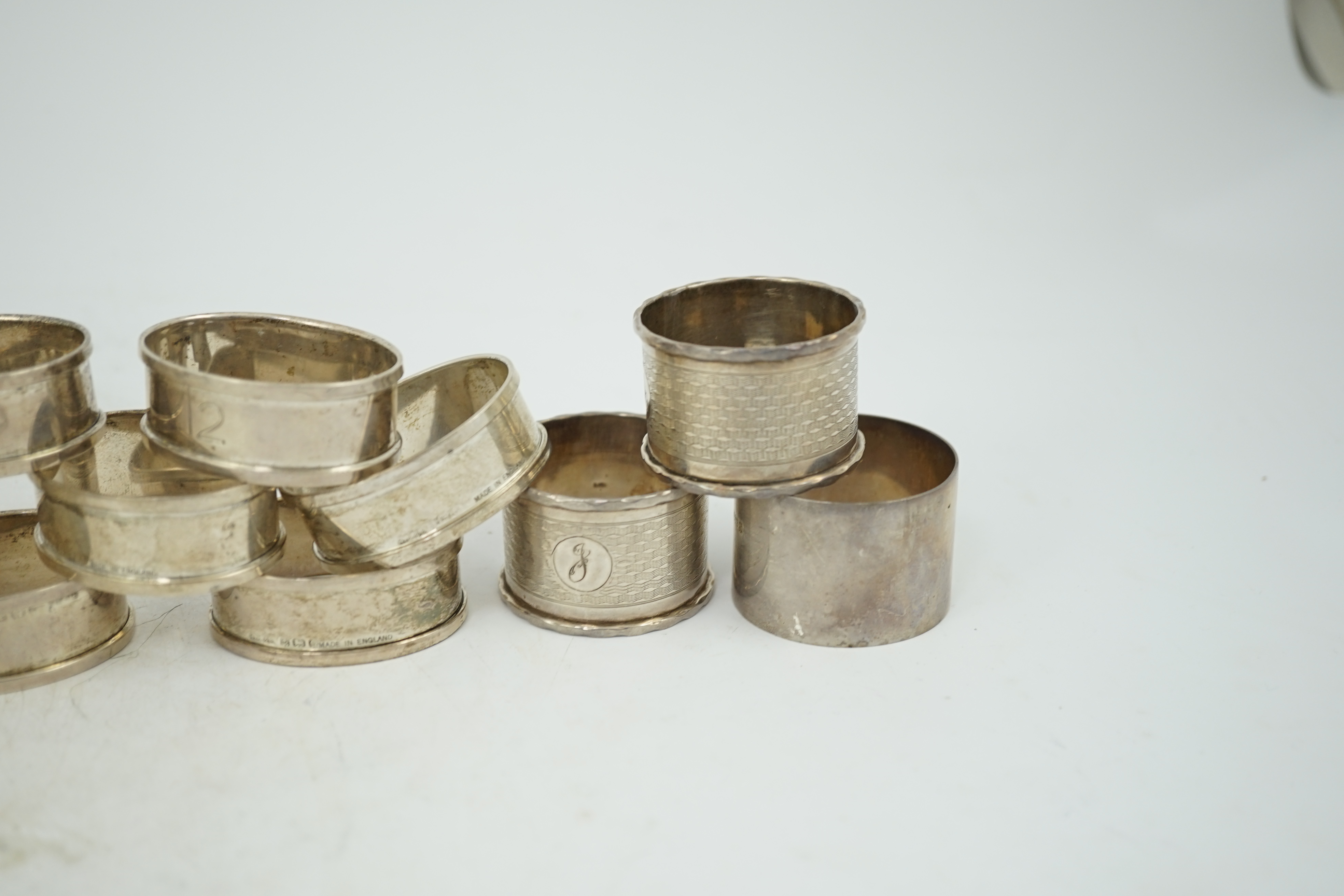 A matched set of eight early 1930's silver napkin rings and four other silver napkin rings including a pair, Birmingham, 1929, 5.3oz.